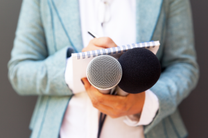 reporter holding microphones